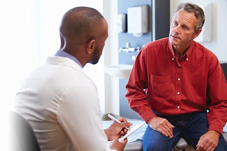 Doctor discussing prostate cancer screening with a male patient.